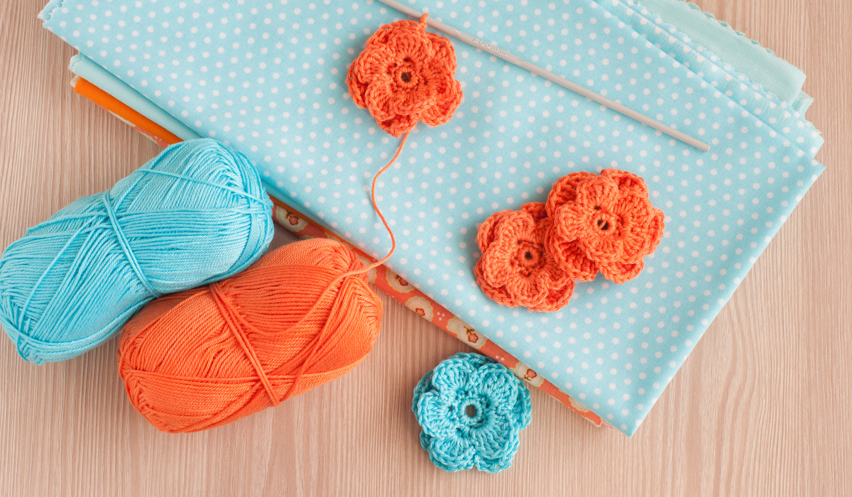Handmade knitted crochet flowers on cloth on the table