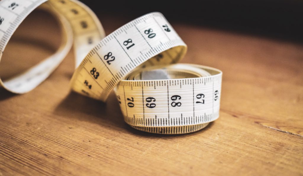 Measuring tape on a wooden surface