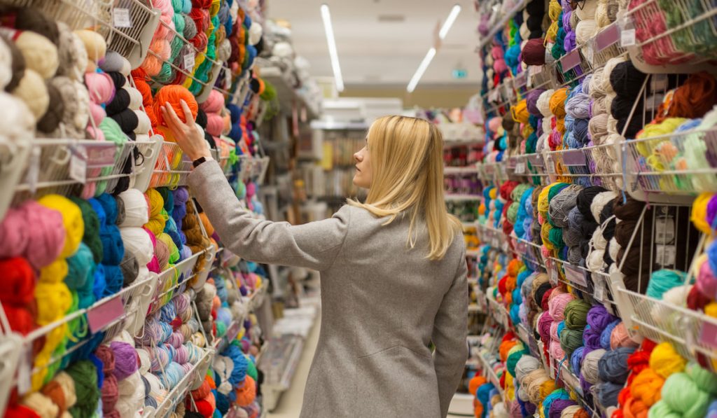 Woman-Choosing-Wool-Yarn-for-Knitting-in-a-shop