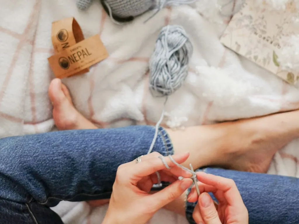 Woman knitting crocheting a amigurumi toy 