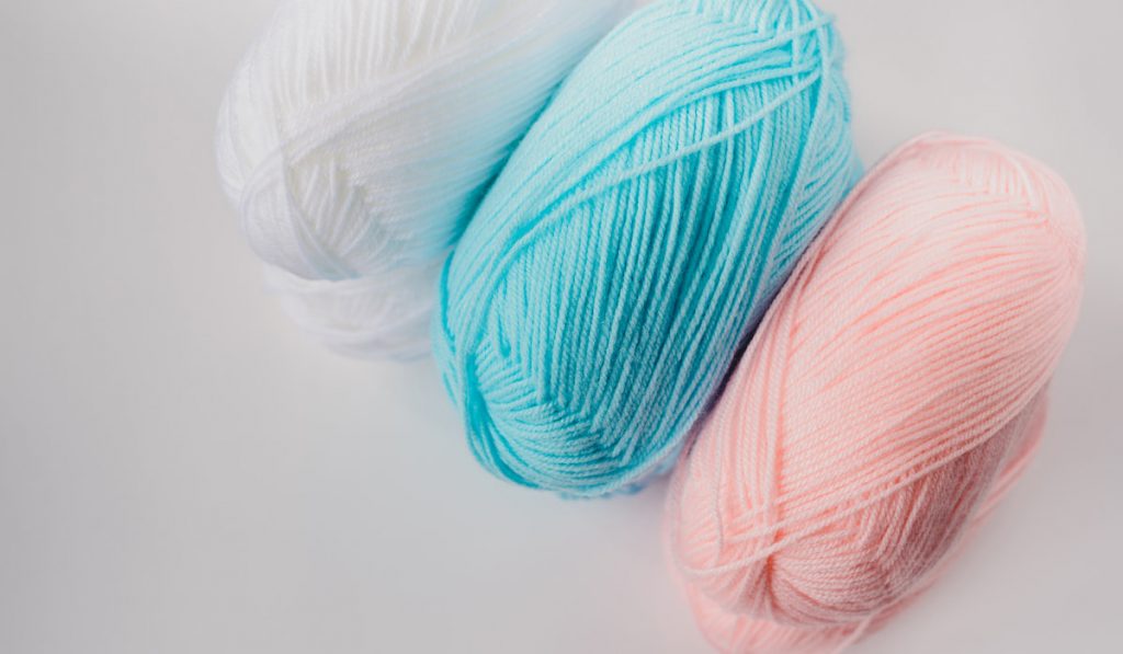 acrylic pastel colored wool yarn on white background