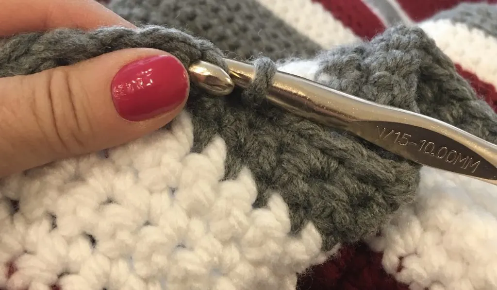 closeup of crocheting a blanket process 