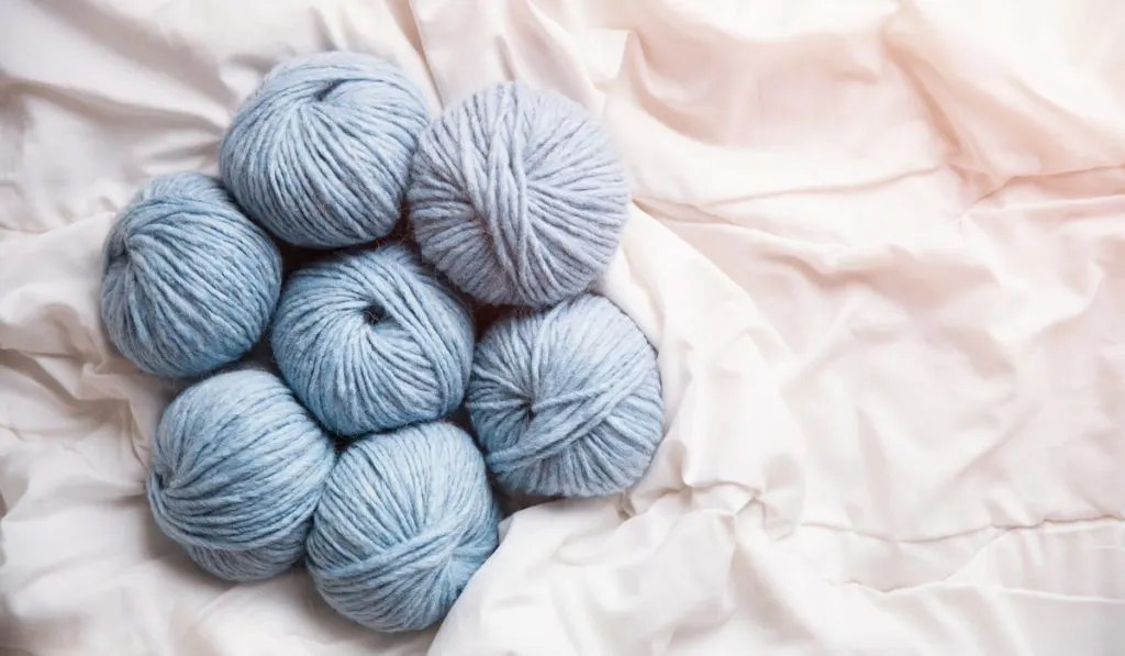light blue Yarn clews on white fabric