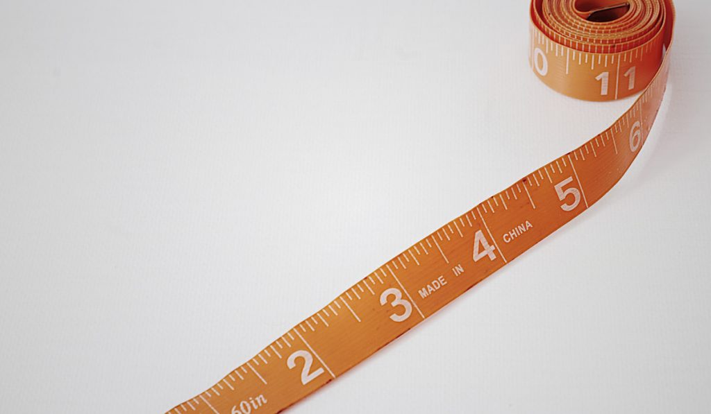 orange Measuring tape on white background 