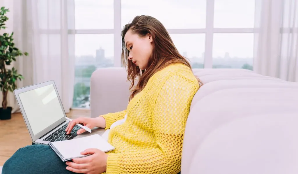 woman sitting on the couch working on her website for marketing