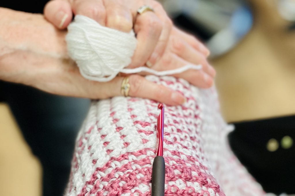 Woman crocheting.