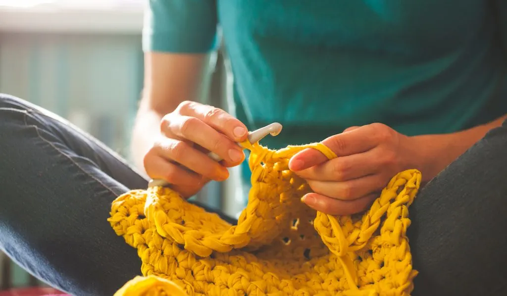 young woman doing crochet