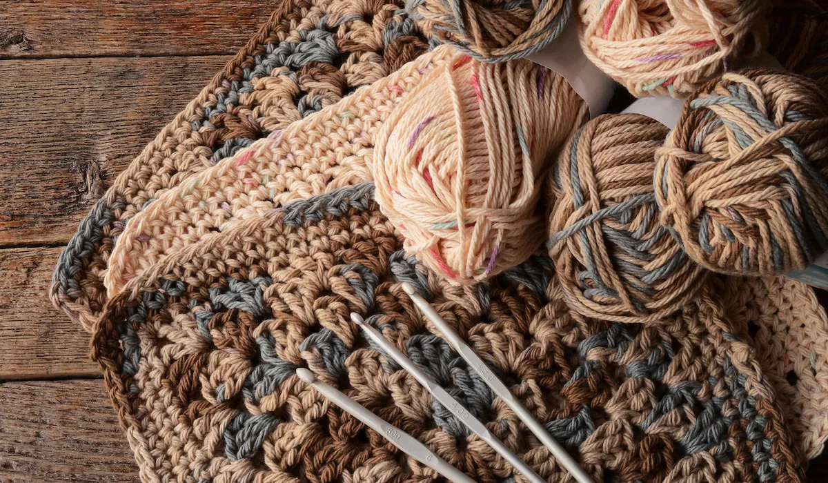 crochet yarn, balls, hook and squares