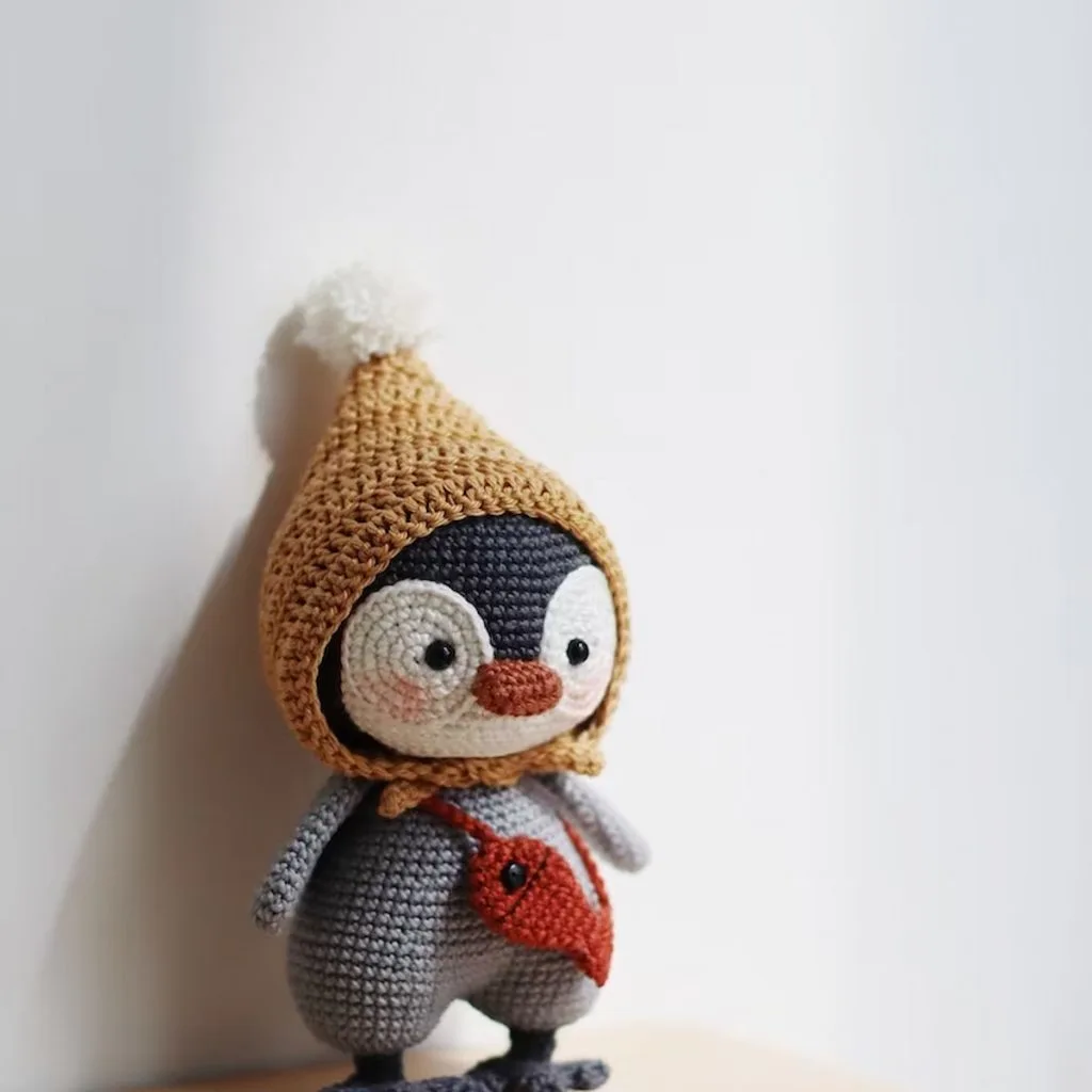 Cora the Little Penguin Crochet Pattern by Hainchan on a wooden table