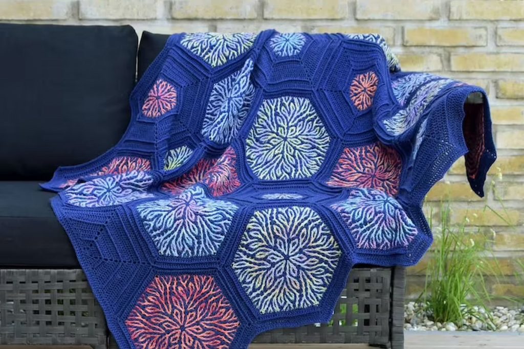 Coral Story Blanket- Brioche Crochet Pattern on a sofa outdoor