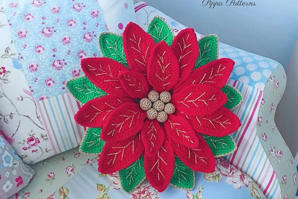 Crochet Poinsettia Cushion by PippaPatternsCrochet on the sofa