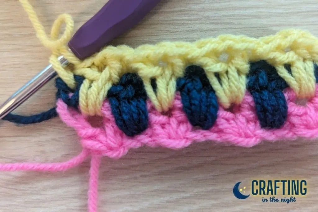 crochet swatch with three rows complete showing start of single crochet for last stitch