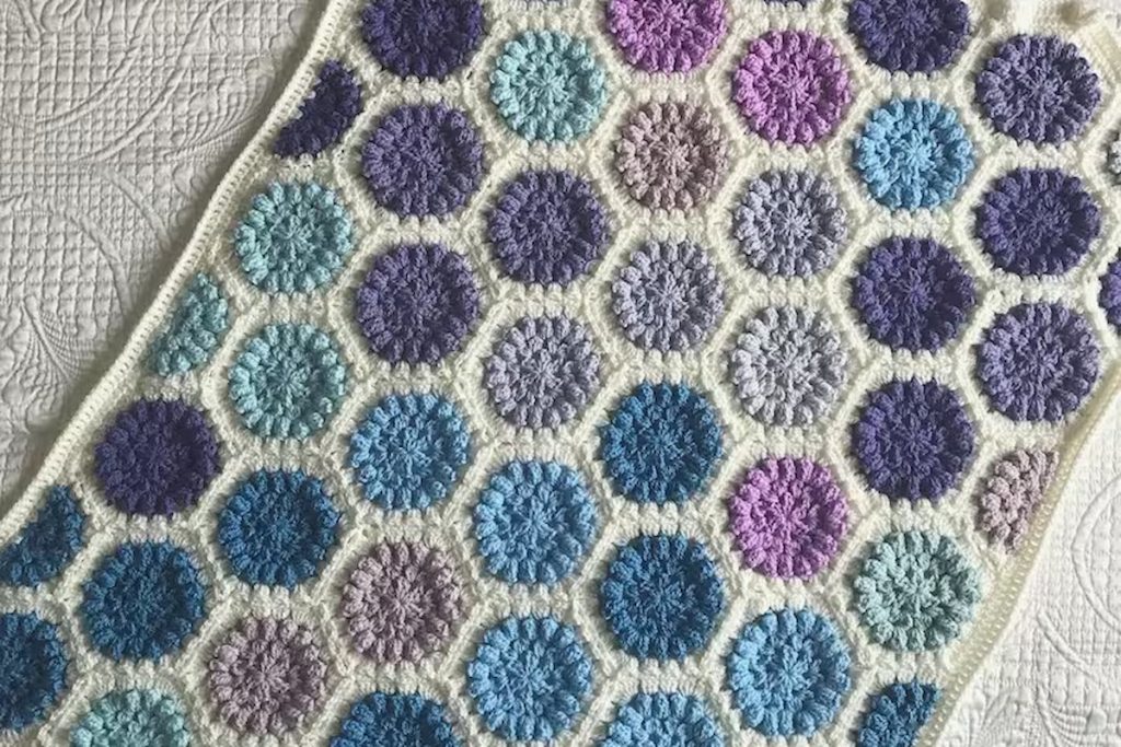 Easy Hexagon Crochet Baby Blanket on white cloth