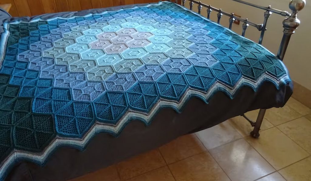Honeycomb Web Blanket Crochet pattern on a bed