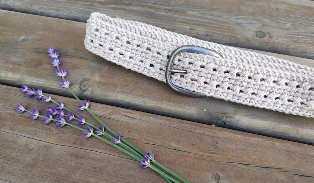Nelly Crochet belt pattern and lavender flowers on wooden table