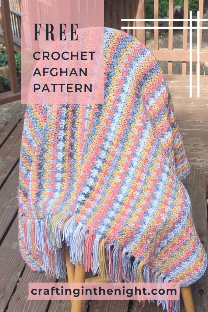 pinterest image showing a completed crochet speedy granny ruth blanket draped on a chair. The words "Free crochet afghan pattern" appear at the top of the pin. The website url, craftinginthenight.co, appears at the bottom of the pin.