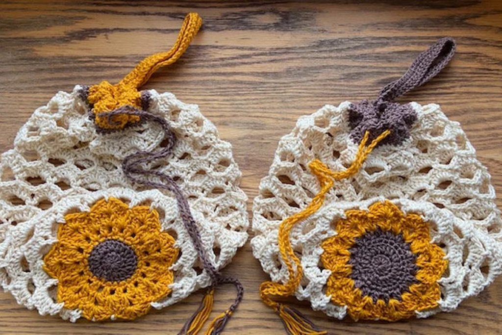 two Sunflower Bag Crochet Pattern bags on wooden table