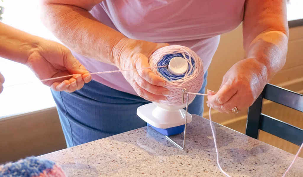 woman setting up the yarn in the yarn winder