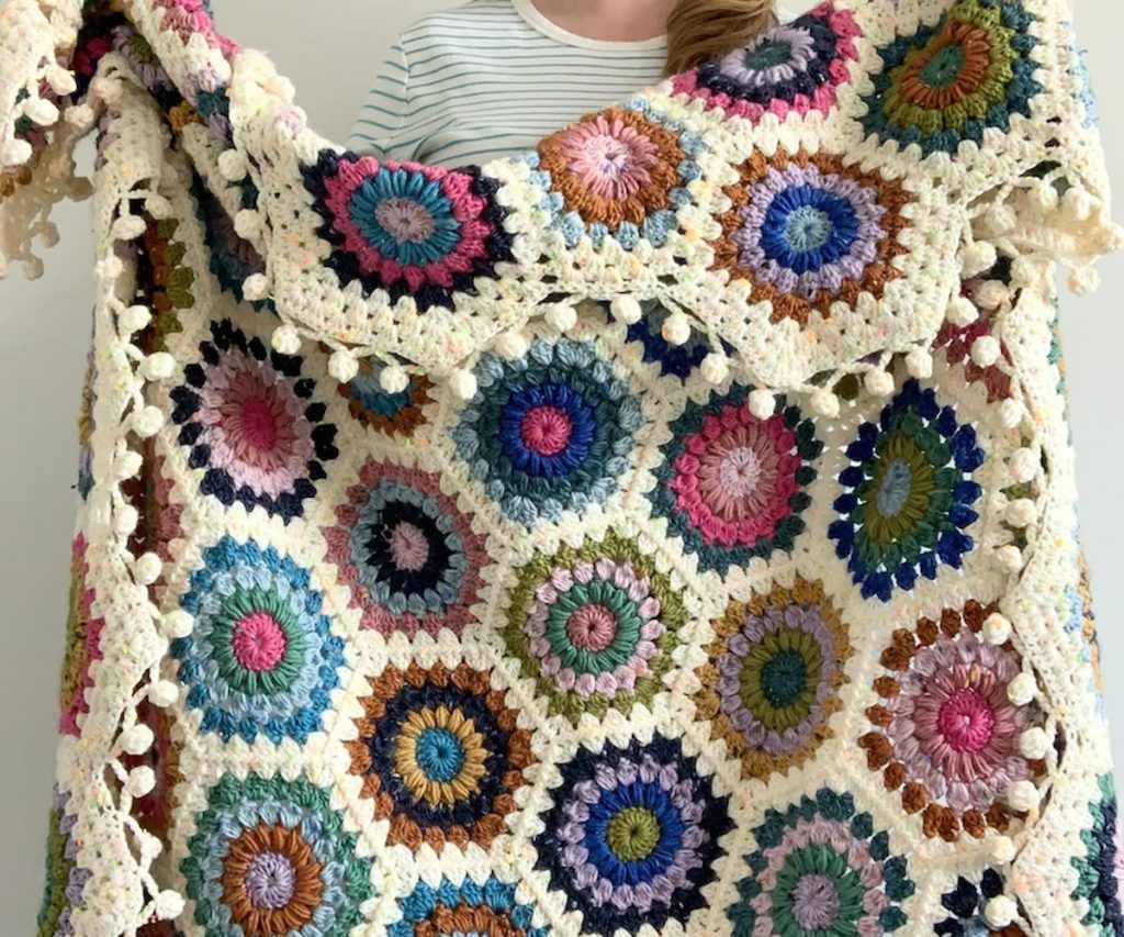 woman holding a Hygge Burst Hexie Blanket Pattern 