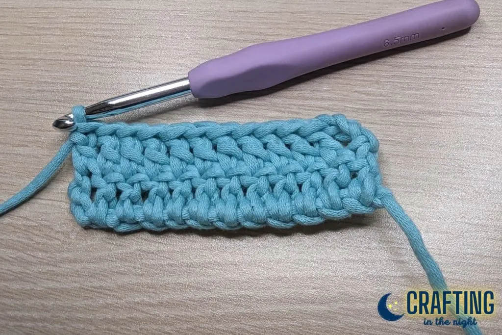 completed two rows of double crochet on the table with the metal crochet hook 