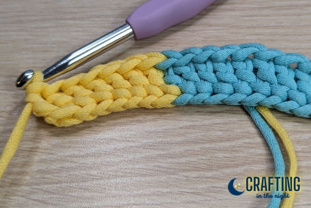 finished double crochet with combined colors blue and yellow on the table