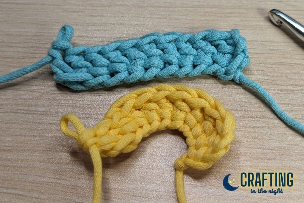 finished blue double crochet and a yellow double crochet with a curling on the table