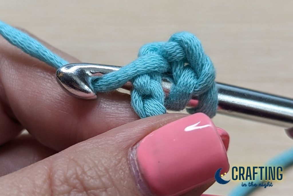 insert crochet hook into the third chain from the hook, under both top loops.