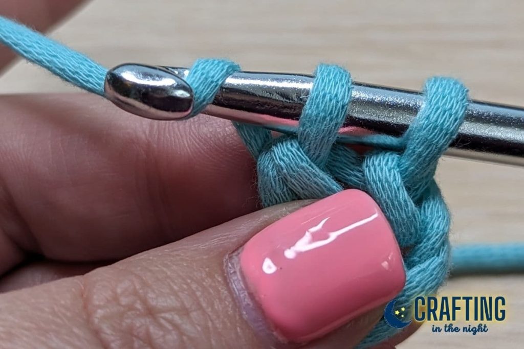 crochet hook with yarn over and two loops