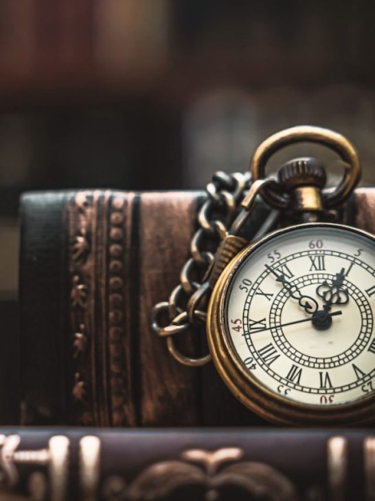 vintage necklace watch sitting on an old book