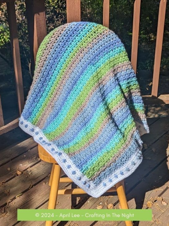 Diamond Weave Blanket over a chair on a deck